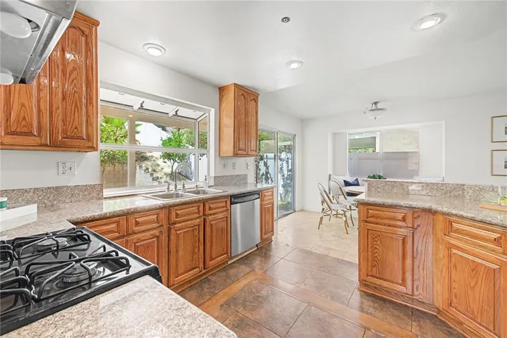 Spacious kitchen with a garden window overlooking the backyard
