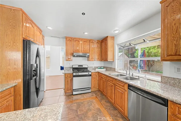 Kitchen featuring custom tile work and recessed ceiling lights