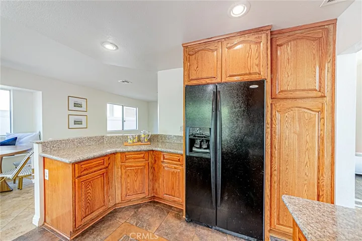 Kitchen featuring granite countertops with refrigerator included