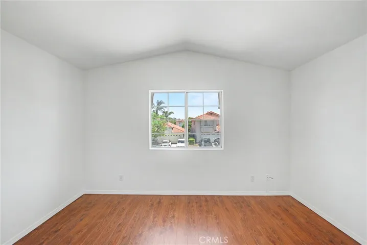 Fifth bedroom offering flexible living space, abundant natural light, and pleasant views