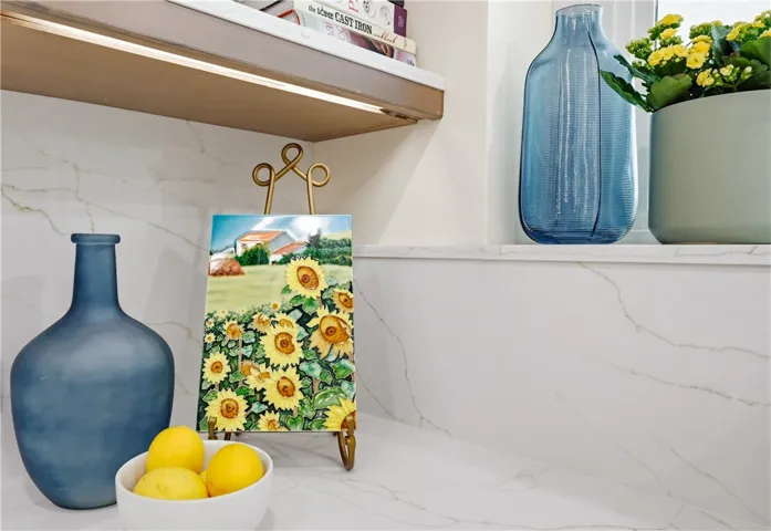 Tasteful quartz countertops and backsplash are highlighted with under-the-counter lighting (on a switch).