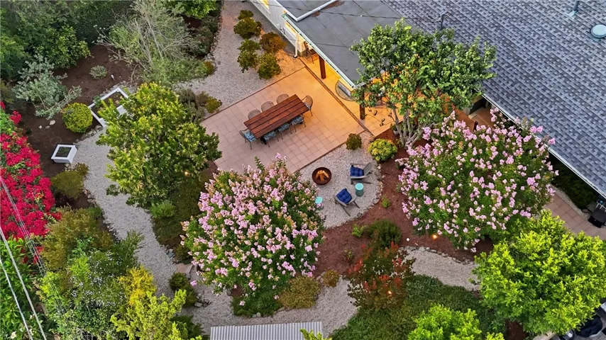 With its crepe myrtle, arbutus, pittosporum, and other trees and vegetation, this exceptional backyard is waiting for you.