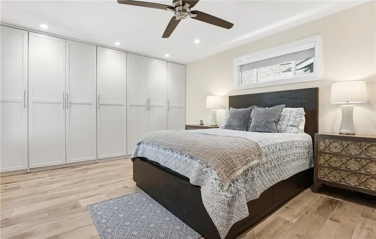 With its custom cabinetry, custom window shades, and ease of flow, the primary bedroom offers a retreat.