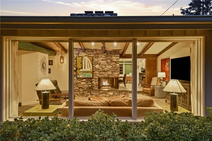 You will love the ambiance created by its vaulted post and beam ceiling and 2-sided fireplace.