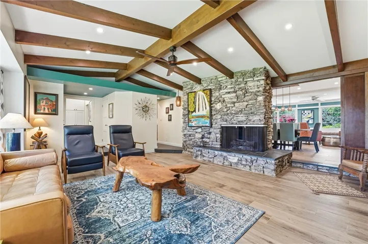 There are two different hearts to this home: the living room and the kitchen/dining room/family room behind it. Off to the left of the entrance is a room used as an office.