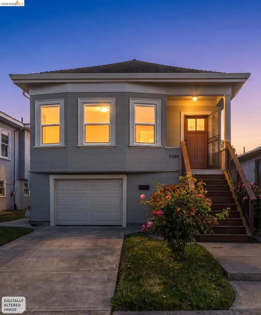 Two-story exterior with light gray siding, an integrated garage, and a concrete driveway