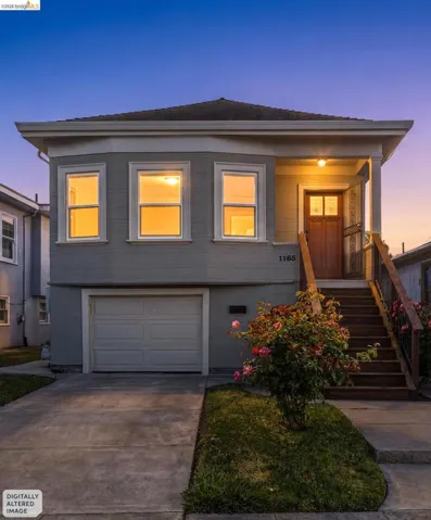 Two-story exterior with light gray siding, an integrated garage, and a concrete driveway