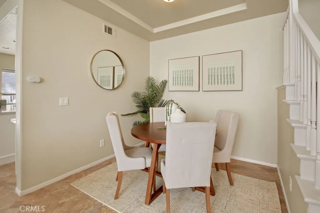 Enjoy casual meals and conversations in this inviting dining area conveniently situated between the kitchen and living spaces.