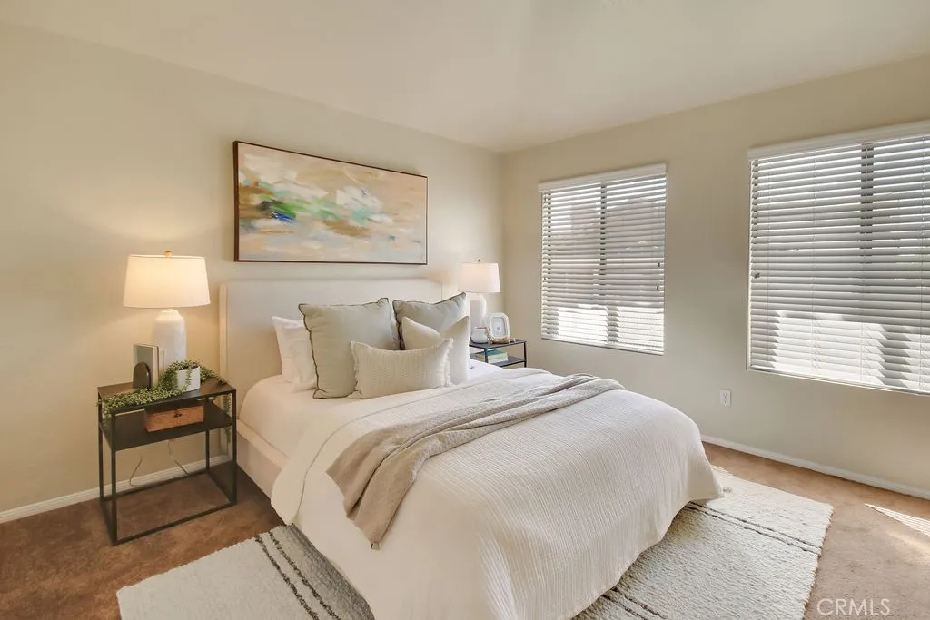 The spacious primary suite offers a peaceful retreat with large windows and plenty of room to unwind.
