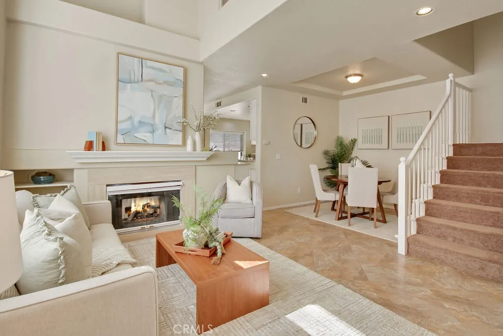 The open-concept floor plan seamlessly blends the living, dining, and entertaining areas beneath soaring ceilings and abundant natural light.