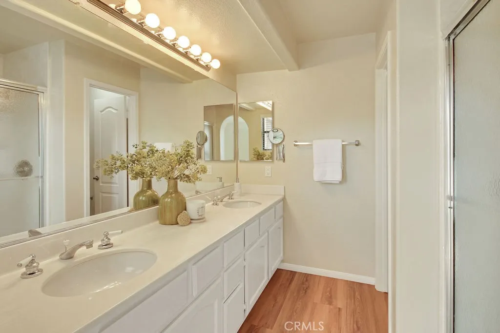 The generously sized primary bath features dual vanities, ample counter space, and a separate shower enclosure.