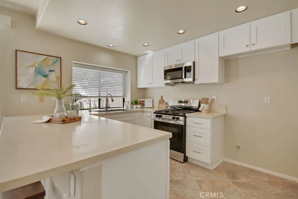 Enjoy preparing meals in this bright and inviting kitchen with modern finishes, generous storage, and a functional breakfast bar.