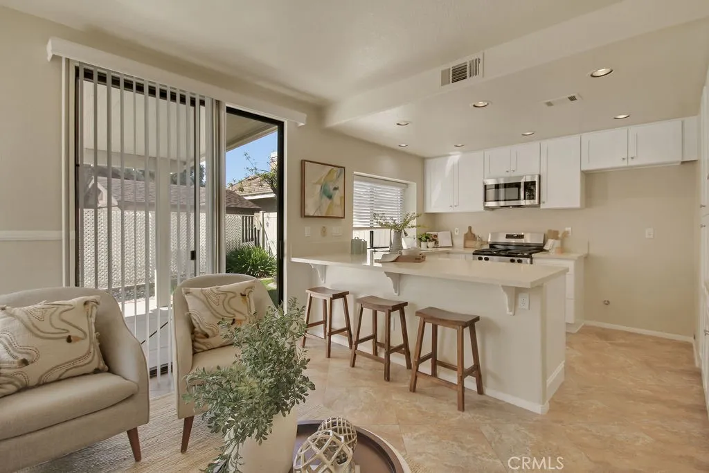 The bright kitchen opens directly to the covered patio, creating an ideal indoor-outdoor living experience.