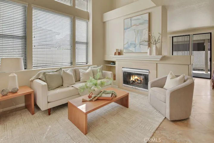Soaring two-story ceilings and expansive windows create a bright, airy living space filled with architectural charm.