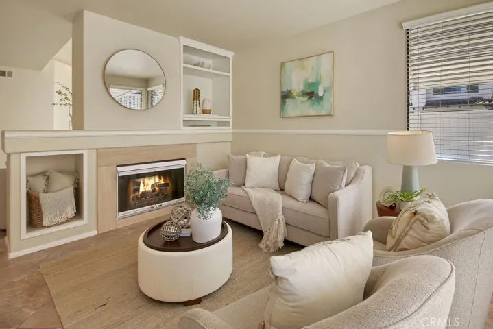 The warm and welcoming family room showcases a cozy fireplace and an abundance of natural light.