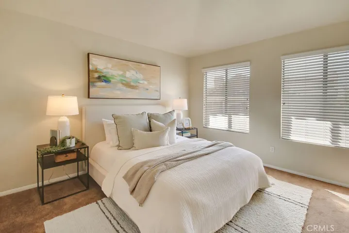 The spacious primary suite offers a peaceful retreat with large windows and plenty of room to unwind.