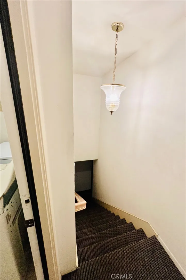 Stairwell to access garage, off laundry room