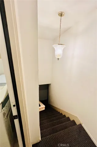 Stairwell to access garage, off laundry room