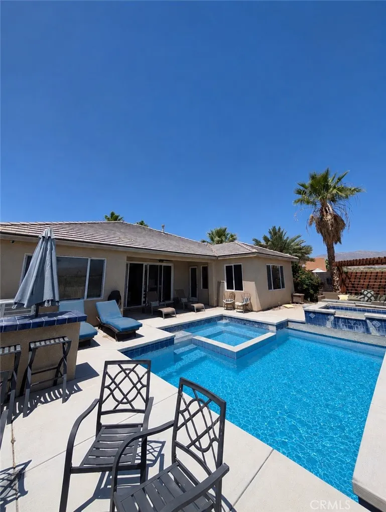 This image has been digitally enhanced to showcase the potential for this beautiful pool oasis and patio.  The pool and spa are in need of repair.