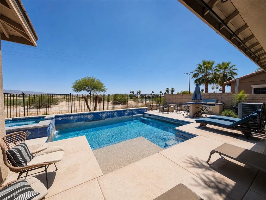 This image has been digitally enhanced to showcase the potential for this beautiful pool oasis and patio.  The pool and spa are in need of repair.