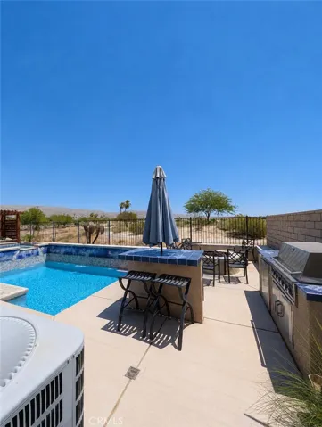 This image has been digitally enhanced to showcase the potential for this beautiful pool oasis and patio.  The pool and spa are in need of repair.