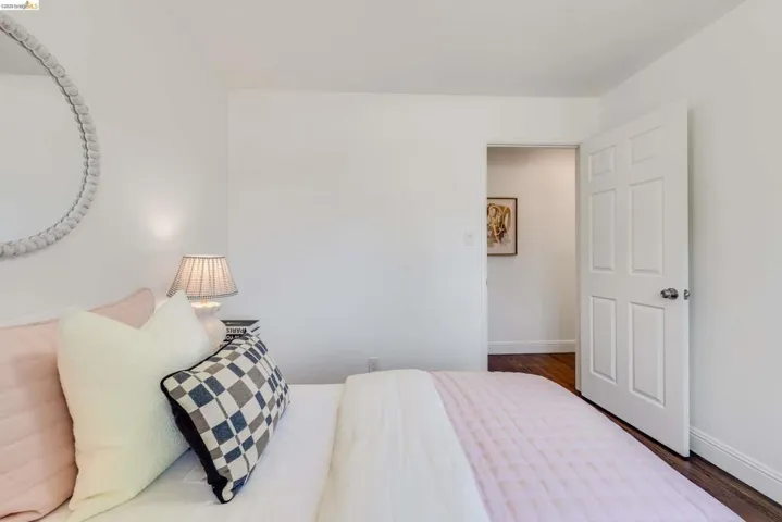 White painted walls with dark wood-finish flooring