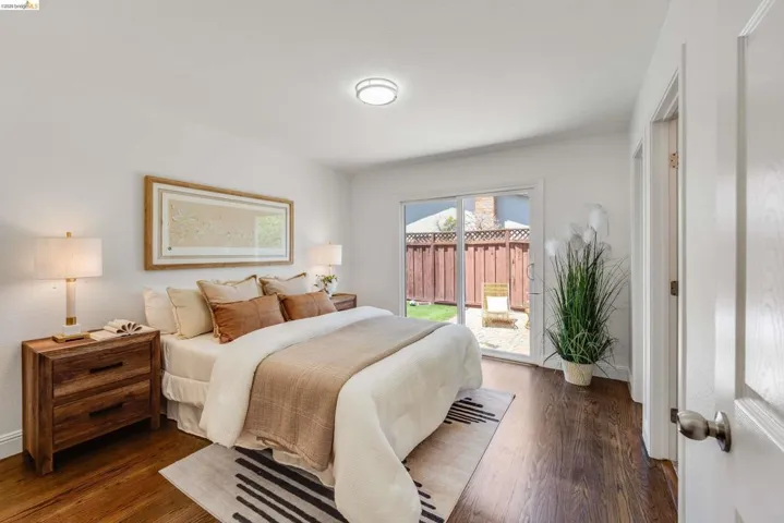 Wood-finish flooring throughout, bright white walls, and a recessed ceiling light