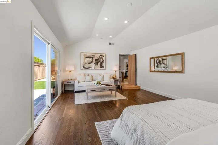 Vaulted ceiling interior space featuring rich wood-finish flooring