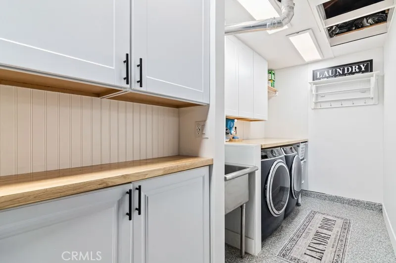 Laundry with workspace, cabinetry and drying station