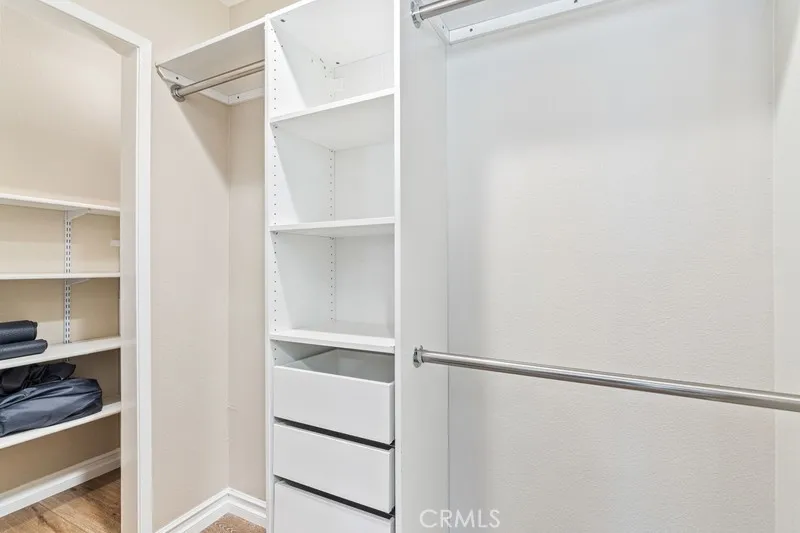 Walk in closet in bedroom #3 with extra storage under the stairs.