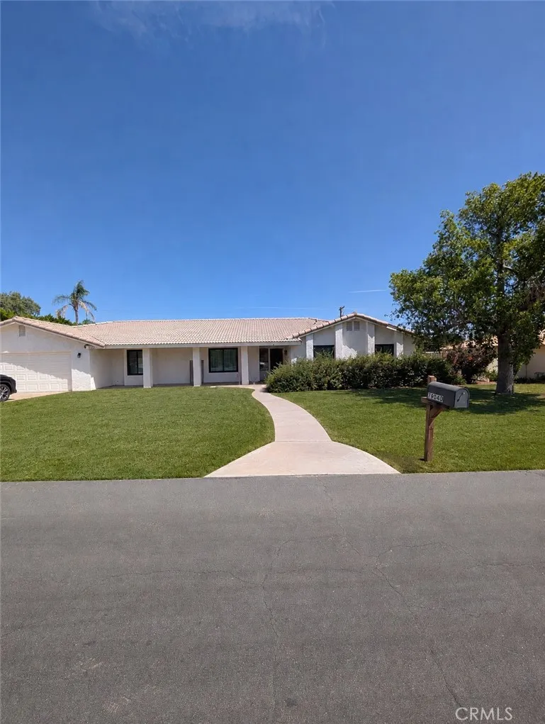 Image has been digitally enhanced to showcase what the front yard could look like.