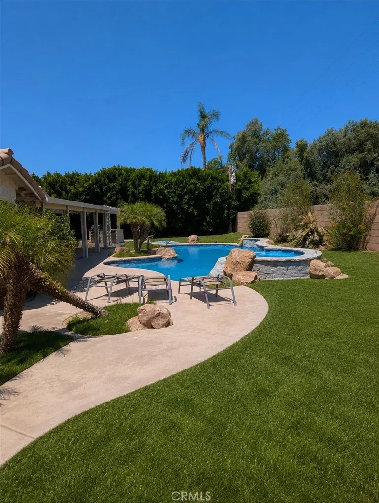 Image has been digitally enhanced to showcase what the backyard can potentially look like.  The backyard and pool and spa are in need of repair.