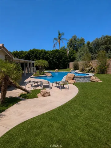 Image has been digitally enhanced to showcase what the backyard can potentially look like.  The backyard and pool and spa are in need of repair.