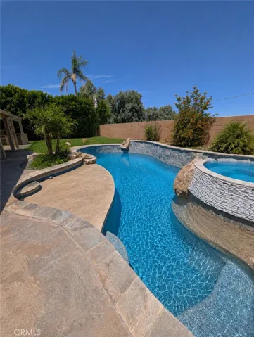 Image has been digitally enhanced to showcase what the backyard can potentially look like.  The backyard and pool and spa are in need of repair.