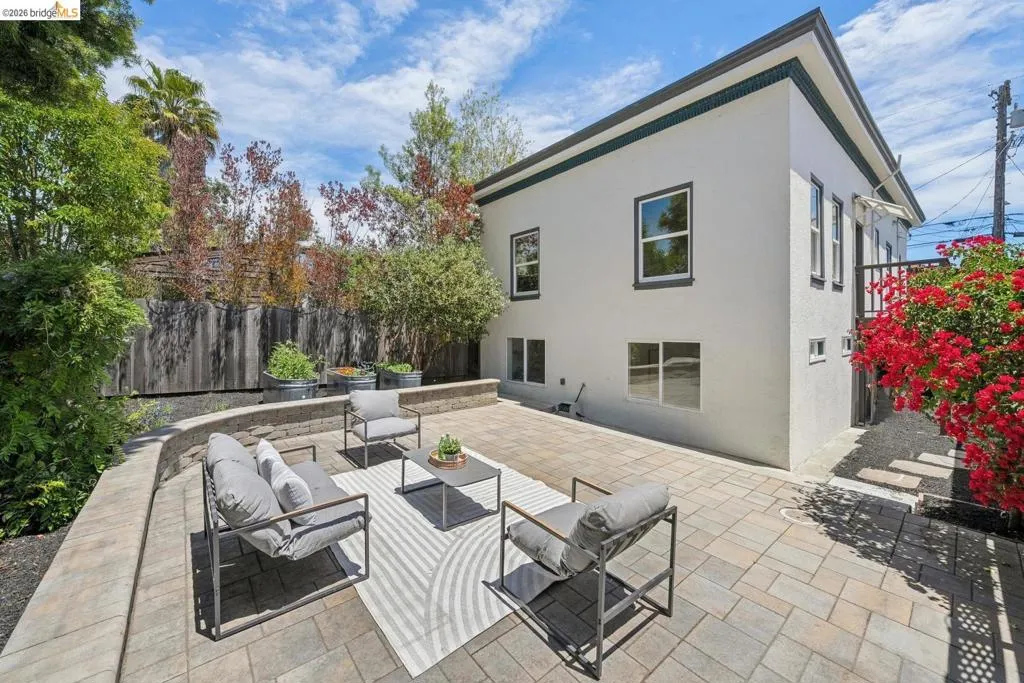 Expansive paved patio with mature perimeter landscaping.