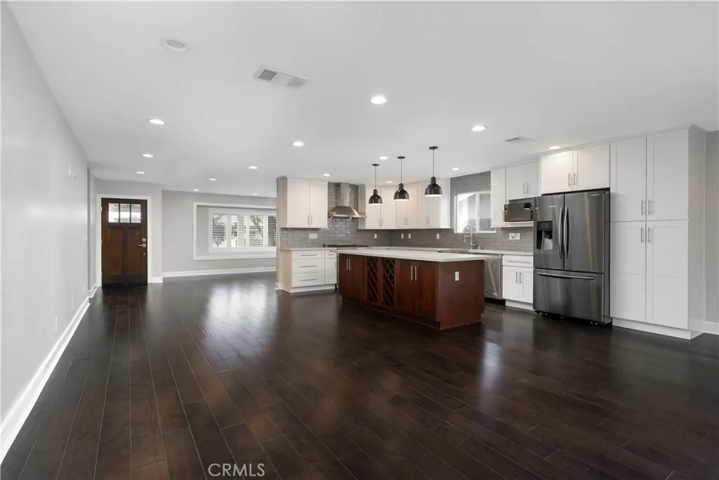 Open floor plan flow from kitchen/dining area to family room