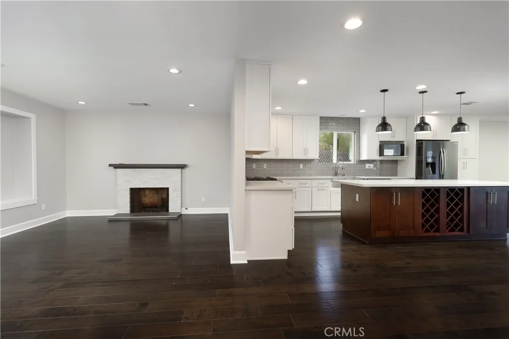 Open floor plan flow from living room to kitchen/dining area