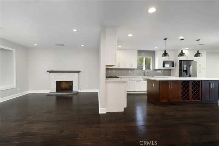 Open floor plan flow from living room to kitchen/dining area