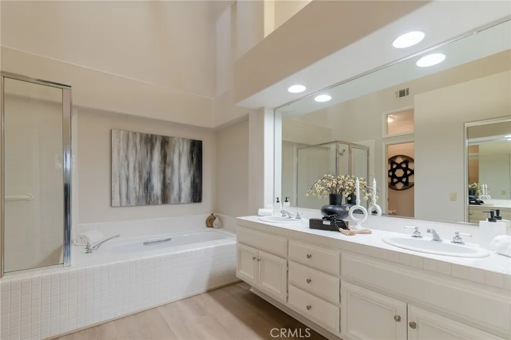 The primary bathroom includes a skylight, dual vanity, a soaking tub and a separate walk-in shower.