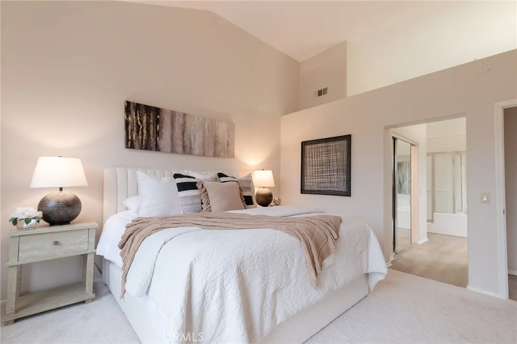 The primary suite features a vaulted ceiling and new carpet.