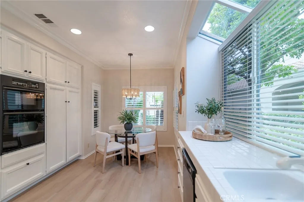 There is vinyl flooring in the kitchen.