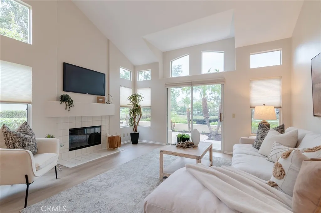 The living room features a vaulted ceiling.