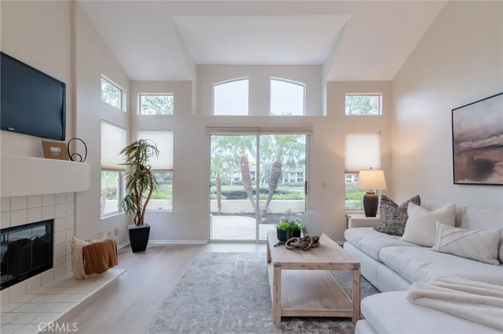 There are large windows in the living room that bring in natural light.