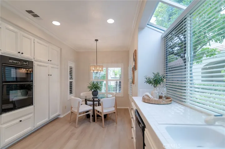 There is vinyl flooring in the kitchen.