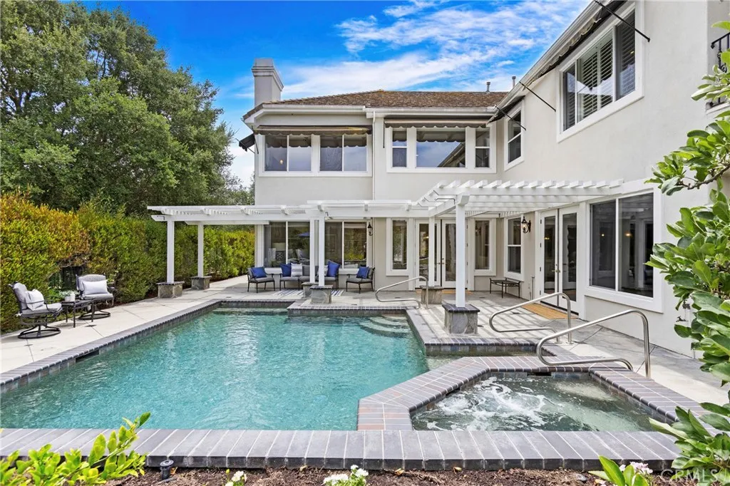 This inviting backyard features a spacious pool and spa, perfect for entertaining and relaxation.