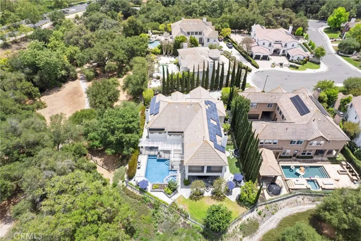Stunning aerial view showcasing a spacious property with luxurious outdoor amenities and lush landscaping.