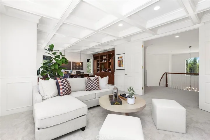 Stunning Coffered ceilings welcome you into the perfect entertaining space with room for a movie night, games party or even space for work/school desk and more (includes TV)