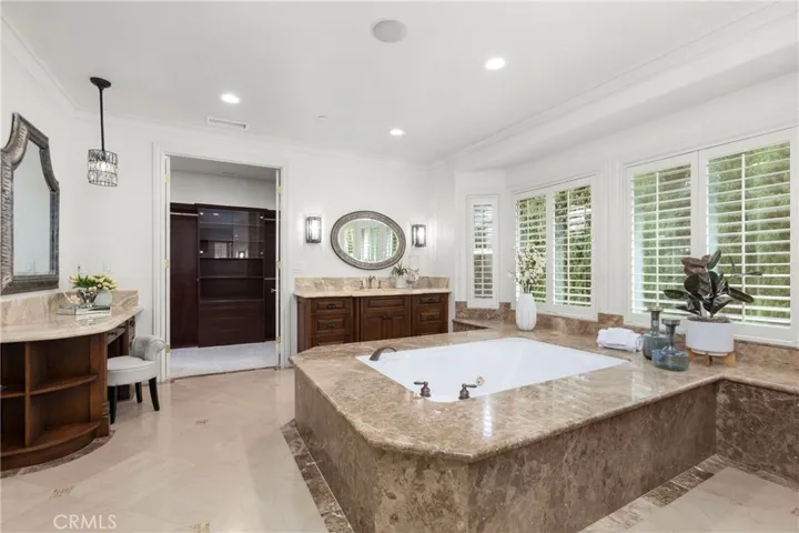 Primary Bathroom -Spacious bathroom featuring a luxurious soaking tub, spacious walk in shower, TV, Toto Neocrest Toilets and a beautifully crafted vanity area. (TV included)