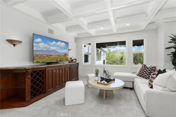 Loft/Entertaining Space featuring large windows, custom cabinetry, and versatile workspace for productivity.