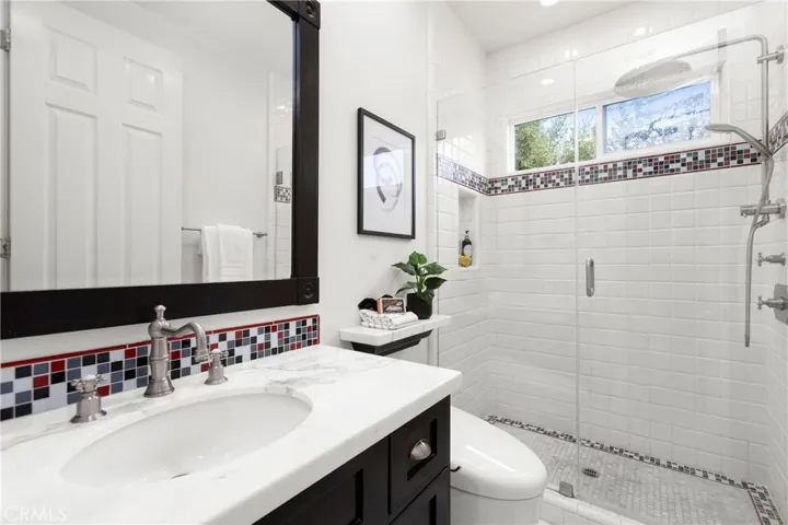 Bathroom 2-Modern bathroom featuring a spacious walk-in shower, sleek fixtures, and vibrant tile accents.